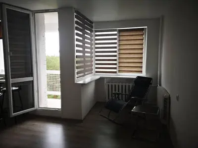 a room with two chairs and two windows at Studio Apartment with Lake View in Visaginas