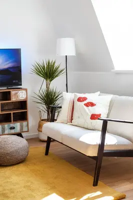 a living room with a white couch and a tv at #stayhere - Modern & Central 2 Bedroom Apartment in Vilnius