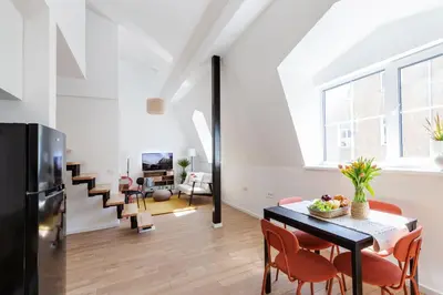 a kitchen and dining room with a table and chairs at #stayhere - Modern & Central 2 Bedroom Apartment in Vilnius