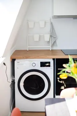 a washer and dryer in a room with a staircase at #stayhere - Modern & Central 2 Bedroom Apartment in Vilnius