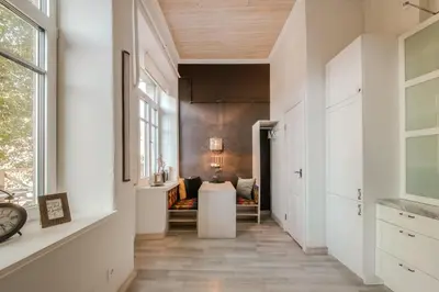 a hallway with a table and a couch at 20 stairs in Vilnius