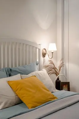 a bed with a yellow pillow on top of it at 20 stairs in Vilnius