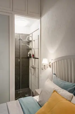 a bedroom with a glass shower and a bed at 20 stairs in Vilnius