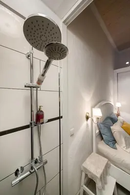 a room with a shower with a bed in it at 20 stairs in Vilnius