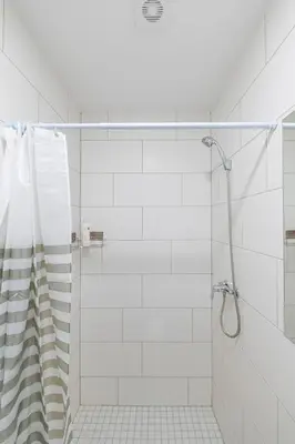 a bathroom with a shower with a glass door at Historical Oldtown Charm with Modern Comfort by Polo Apartments in Kaunas