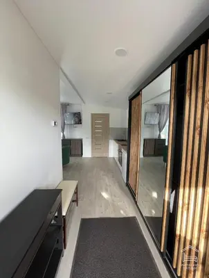 a hallway of a house with a living room at Apartamentai Biržuose, Cozy Modern Bungalows in Biržai