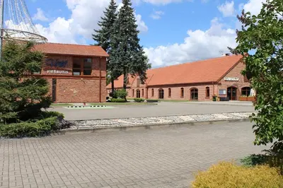 a building next to a river with a building at LUNA Marijampole in Marijampolė