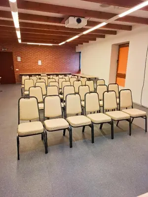 a room with rows of chairs in a classroom at LUNA Marijampole in Marijampolė
