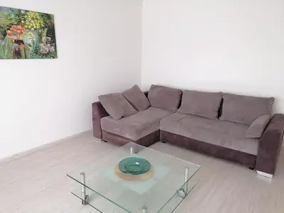 a living room with a couch and a glass table at Antonio house in Ramučiai