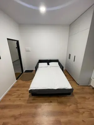 a bedroom with a bed in the middle of a room at 29 Airport Apartment in Vilnius