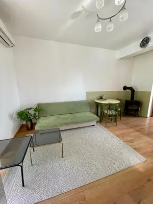 a living room with a green couch and a table at Kaunas Green in Kaunas