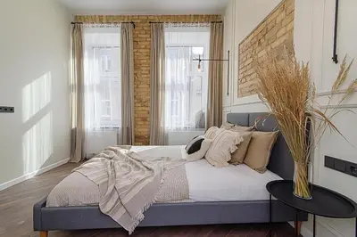 a bedroom with a bed with pillows on it at FREE PARKING Old Town Central Station Apart with Balcony in Vilnius