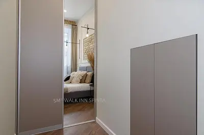 a sliding door in a room with a bedroom at FREE PARKING Old Town Central Station Apart with Balcony in Vilnius