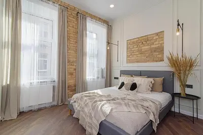 a bedroom with a large bed and two windows at FREE PARKING Old Town Central Station Apart with Balcony in Vilnius