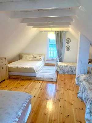a bedroom with two beds and a window at Sodyba Paukščių Takas in Aviliai