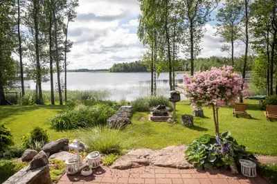 a garden with a view of a lake at Sodyba Paukščių Takas in Aviliai