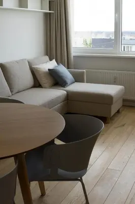 a living room with a couch and a table at VANDUO Anykščiuose in Anykščiai