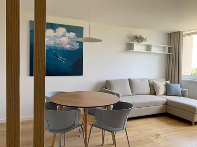 a living room with a table and a couch at VANDUO Anykščiuose in Anykščiai