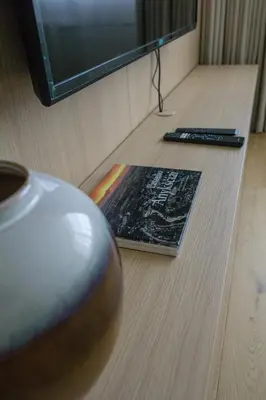 a vase sitting on the floor in front of a television at SMĖLIS Anykščiuose in Anykščiai