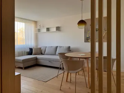 a living room with a couch and a table at SMĖLIS Anykščiuose in Anykščiai
